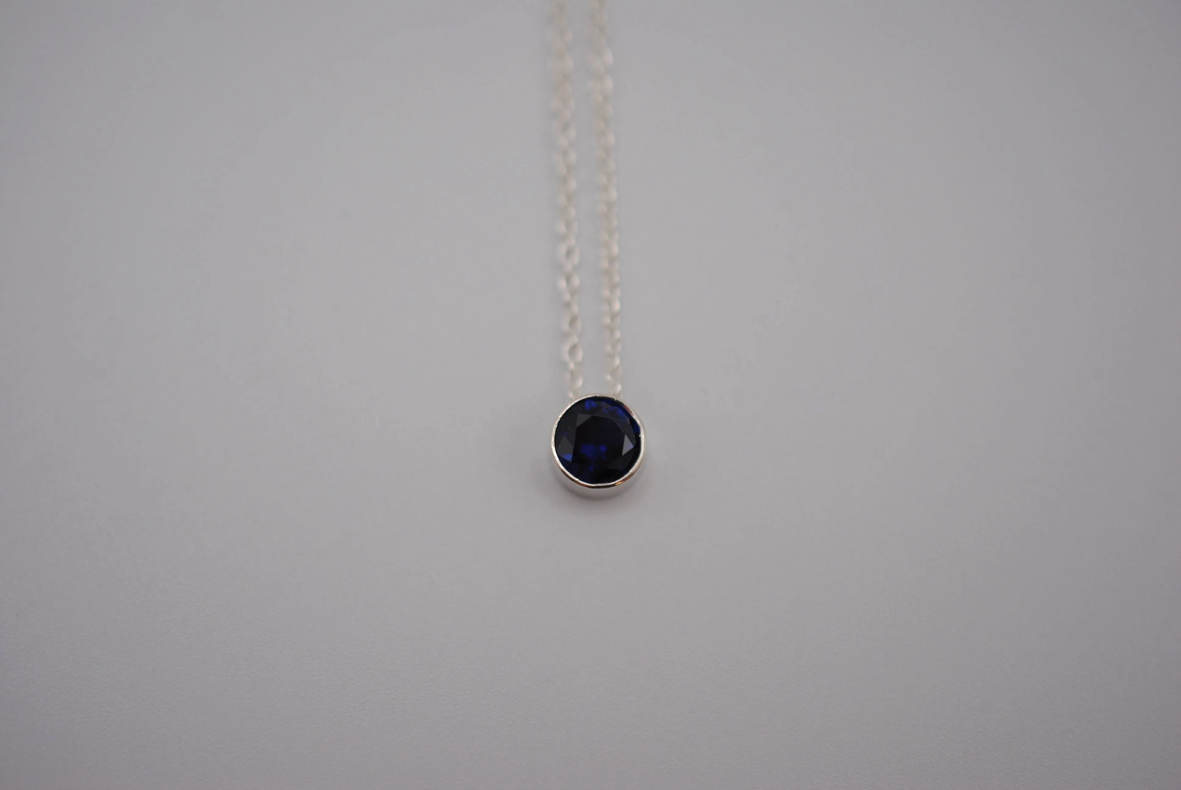Birthstone Necklace: Round Sapphire, Silver Bezel, on Cable Chain