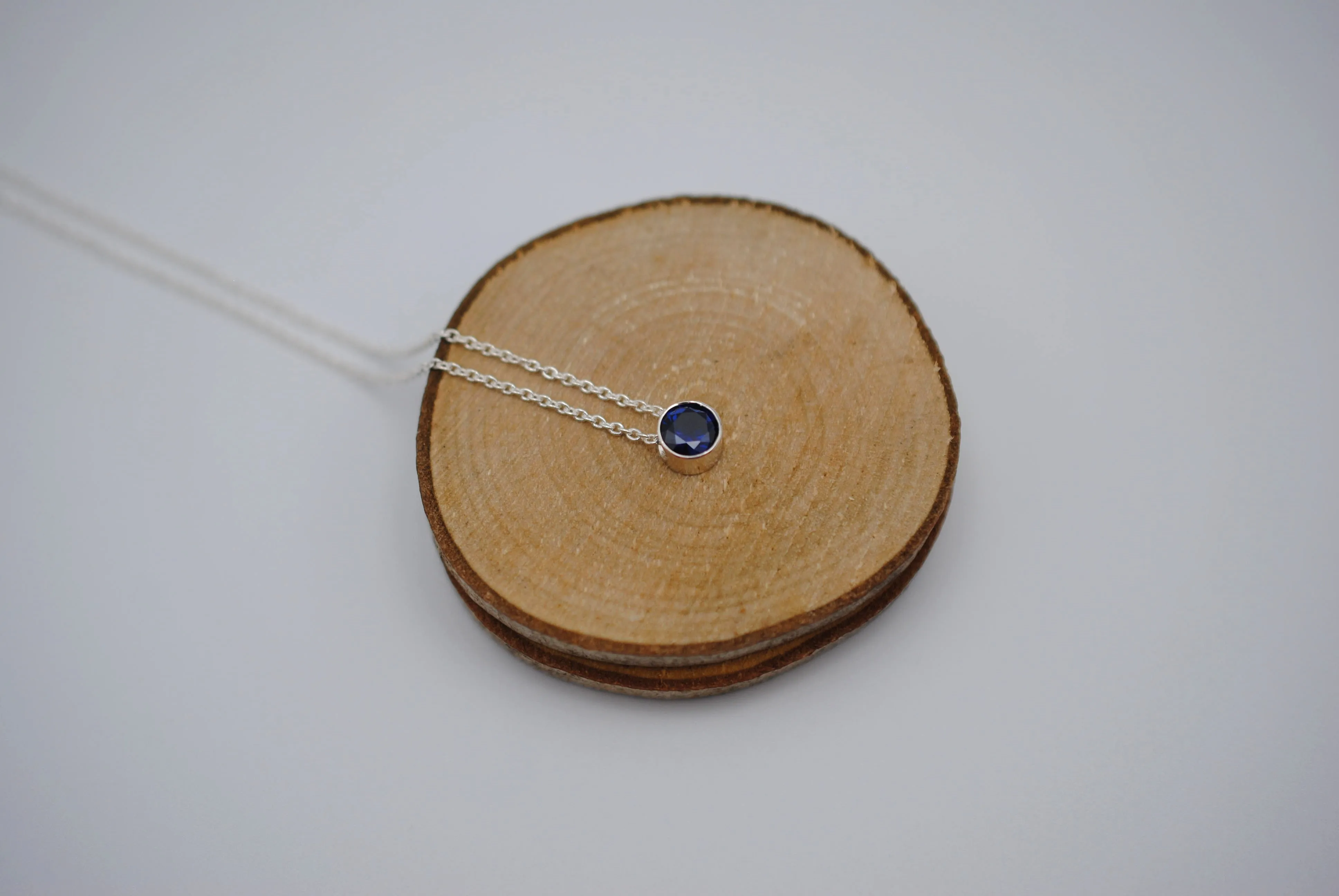 Birthstone Necklace: Round Sapphire, Silver Bezel, on Cable Chain