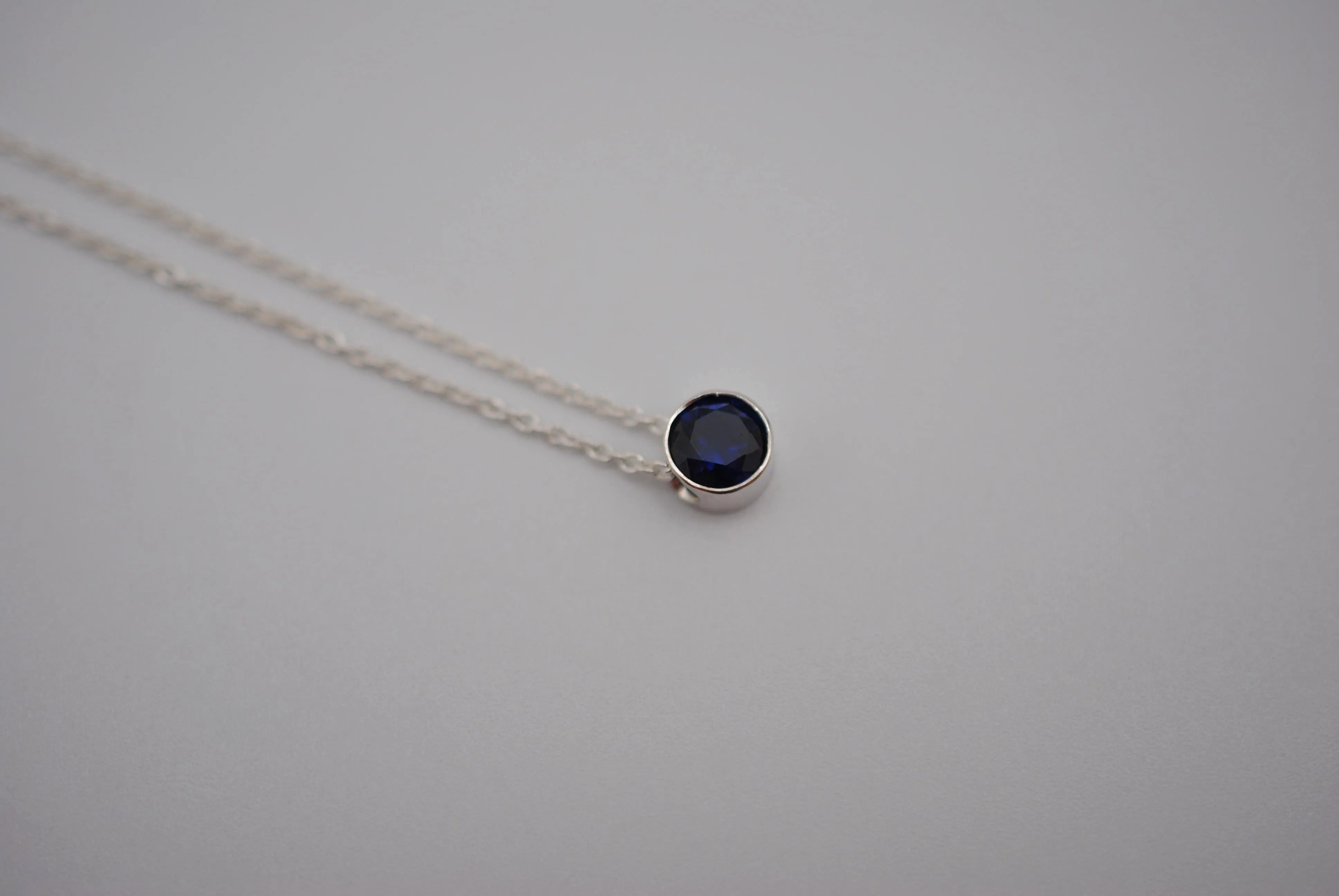 Birthstone Necklace: Round Sapphire, Silver Bezel, on Cable Chain